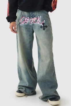 Extreme Baggy Rigid Pu Cross Applique Washed Jeans | BoohooMAN UK